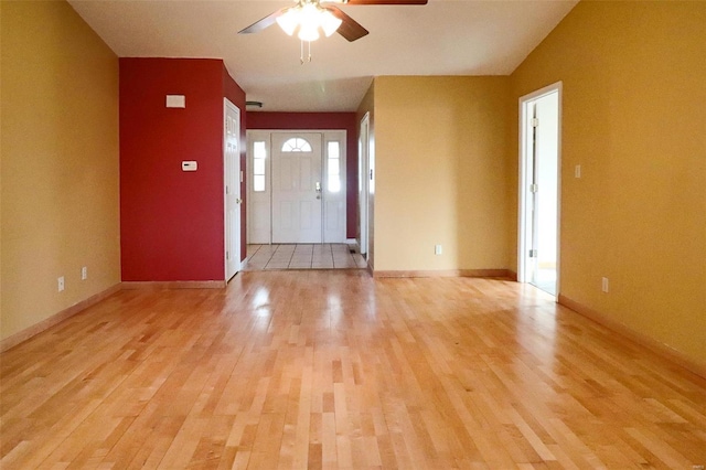 entrance foyer with ceiling fan and light hardwood / wood-style flooring