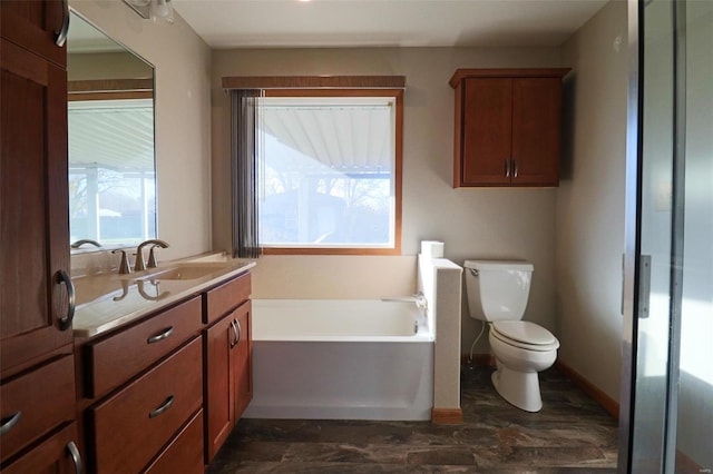 bathroom featuring vanity, toilet, and a bathtub