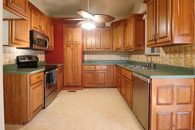 kitchen featuring ceiling fan, decorative backsplash, sink, and appliances with stainless steel finishes