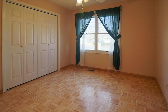 unfurnished bedroom featuring ceiling fan and light parquet floors