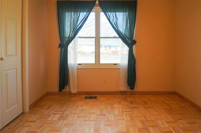 unfurnished room featuring light parquet flooring