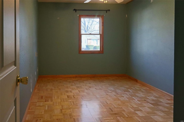 empty room featuring light parquet floors and ceiling fan