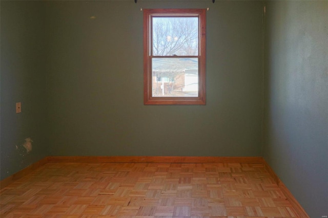 unfurnished room featuring light parquet floors and a healthy amount of sunlight