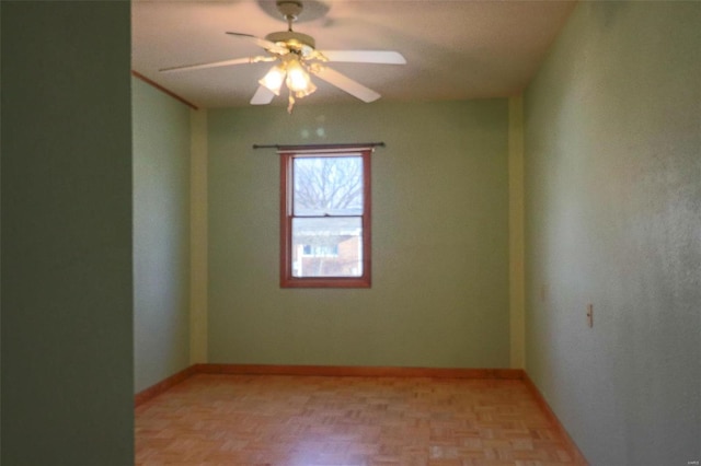 empty room featuring ceiling fan and light parquet flooring