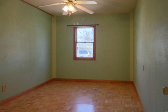 spare room featuring light parquet floors and ceiling fan