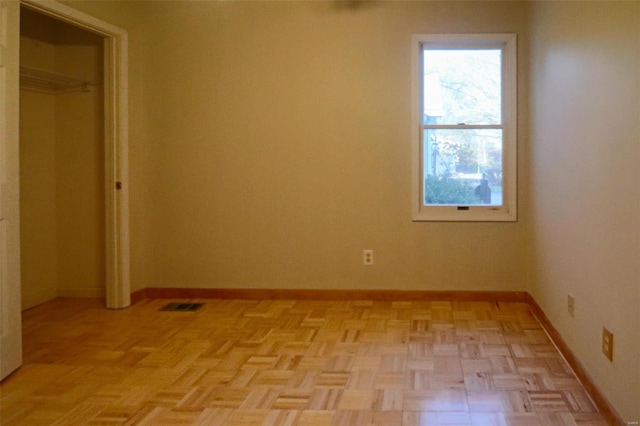 unfurnished bedroom featuring light parquet floors