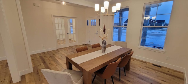 dining room featuring light hardwood / wood-style flooring and a chandelier