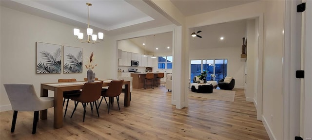 dining space featuring light hardwood / wood-style flooring and a chandelier