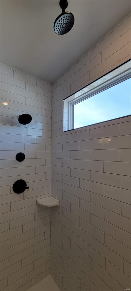 bathroom with a tile shower