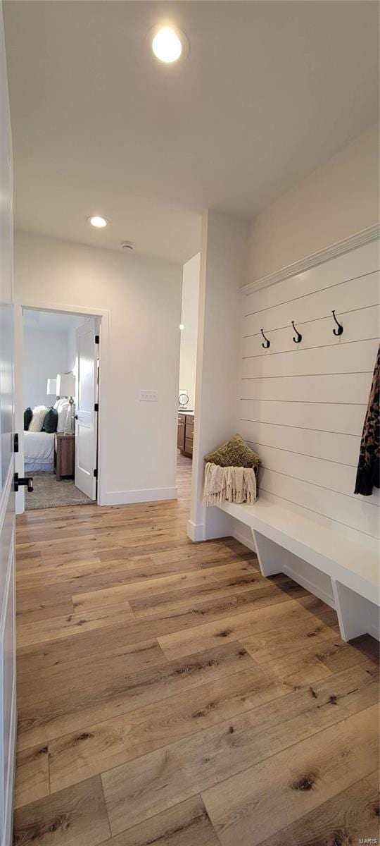 mudroom with light hardwood / wood-style flooring