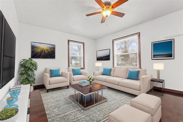 living room with dark hardwood / wood-style floors, ceiling fan, and a wealth of natural light