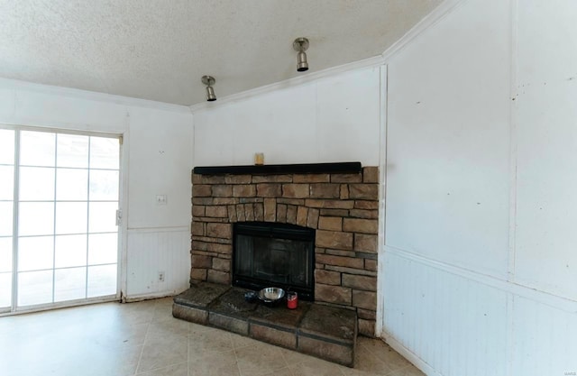 details featuring a stone fireplace, ornamental molding, and a textured ceiling