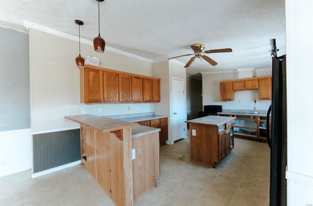 kitchen featuring pendant lighting, crown molding, and a kitchen island