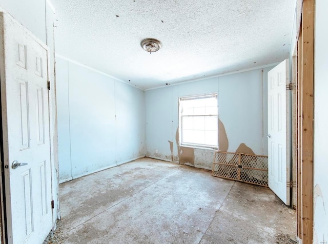 unfurnished room featuring a textured ceiling