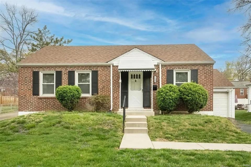 view of front facade with a garage and a front lawn