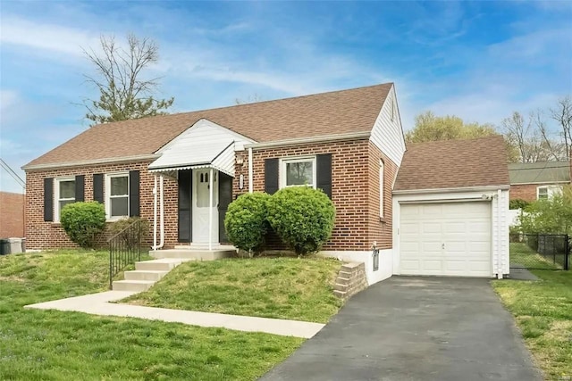 view of front of home with a front lawn and a garage