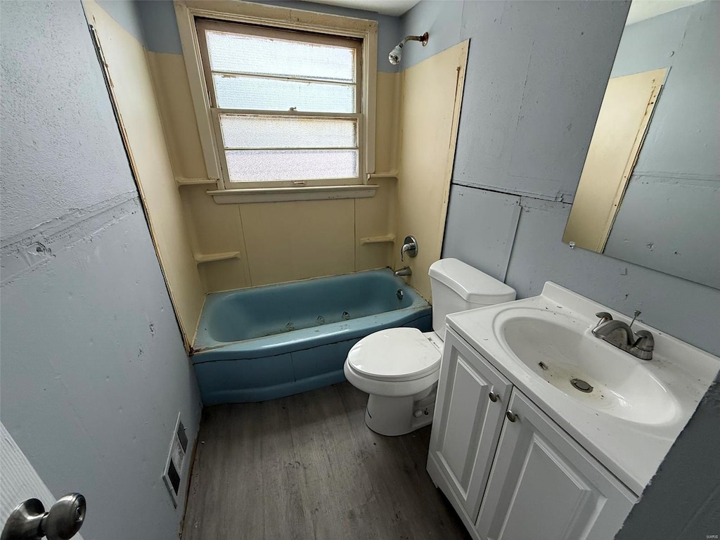 full bathroom featuring vanity,  shower combination, toilet, and wood-type flooring