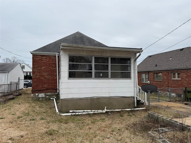 back of property featuring a lawn