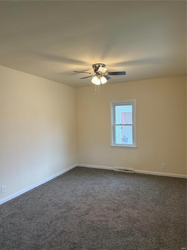 carpeted spare room featuring ceiling fan