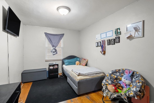 bedroom with hardwood / wood-style floors