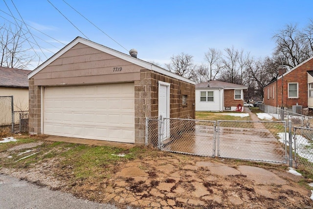 view of front of property with central AC unit, a garage, and an outdoor structure