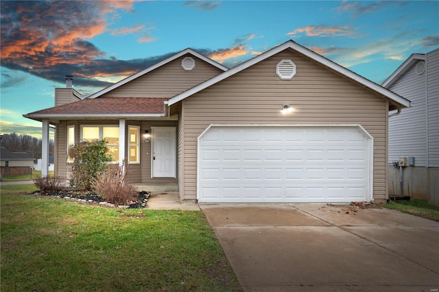 view of front of property featuring a lawn and a garage