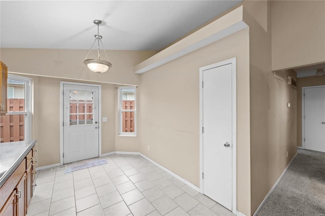 interior space with light tile patterned floors and lofted ceiling