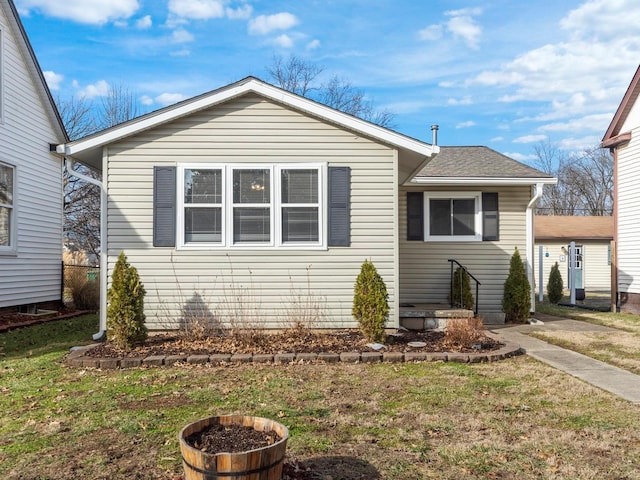 bungalow-style home featuring a front yard