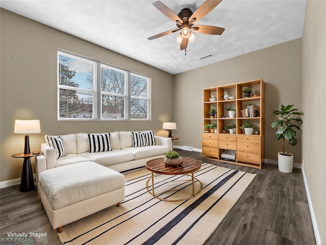 living room with ceiling fan and dark hardwood / wood-style flooring