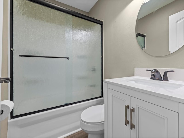 full bathroom with vanity, toilet, and combined bath / shower with glass door