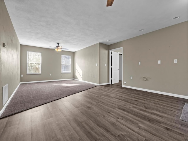 spare room with dark hardwood / wood-style flooring and ceiling fan