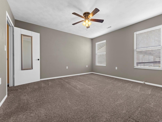 spare room with carpet and ceiling fan