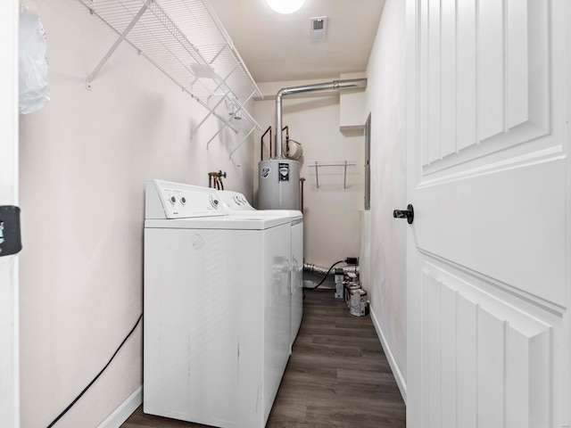 laundry area with washer and dryer, dark wood-type flooring, and water heater