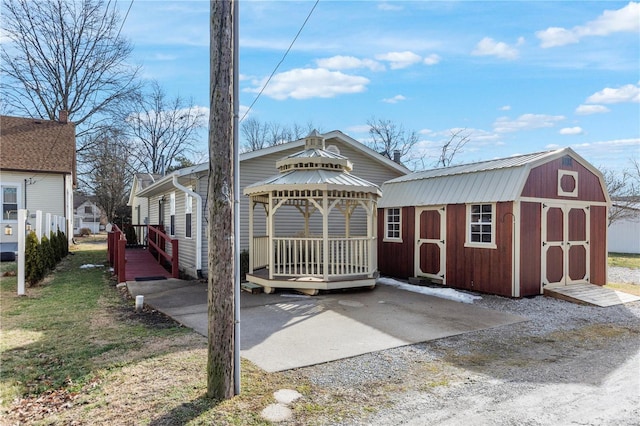 exterior space featuring a gazebo and a storage unit