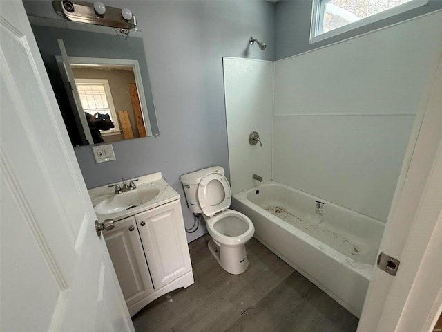 full bathroom with shower / washtub combination, vanity, wood-type flooring, and toilet