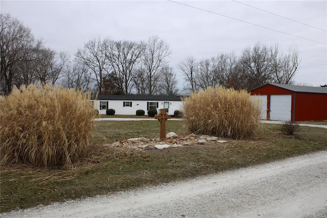 view of front of house with an outdoor structure and a garage