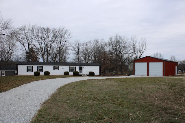 view of front facade with a garage, a front lawn, and an outdoor structure