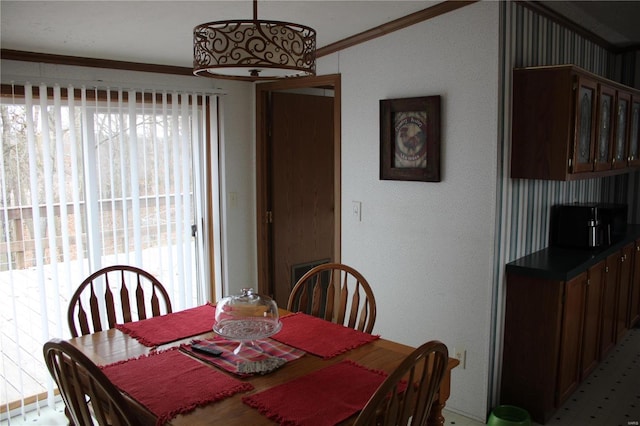 dining room featuring plenty of natural light and ornamental molding