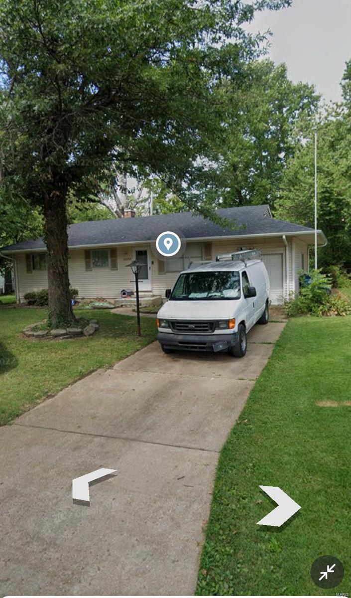 view of front of property featuring a garage and a front lawn