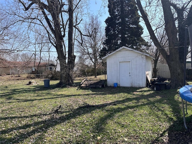 view of yard with a storage unit, an outdoor structure, and fence