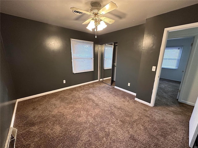 unfurnished bedroom featuring a ceiling fan, baseboards, and carpet floors