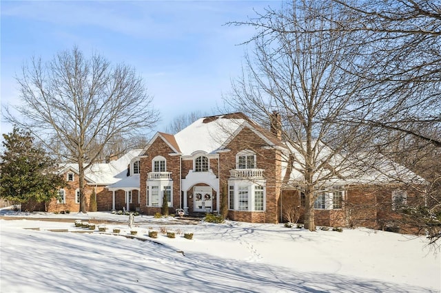 view of front of property with brick siding and a chimney