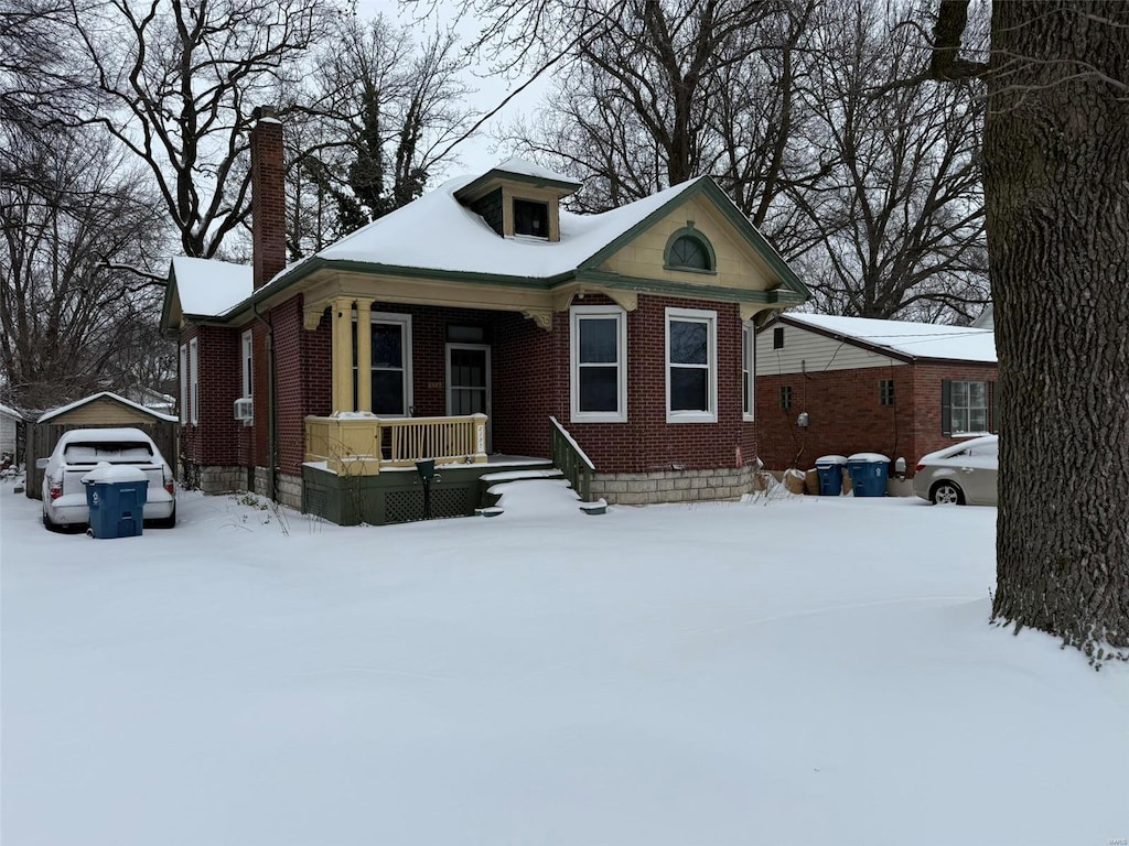 view of front of house with an outbuilding, covered porch, and a garage