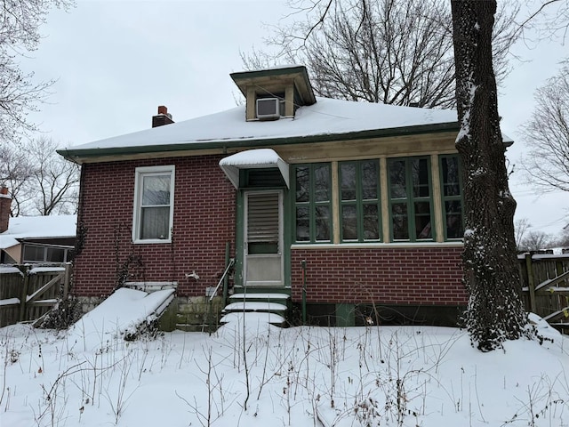 bungalow-style house with a sunroom