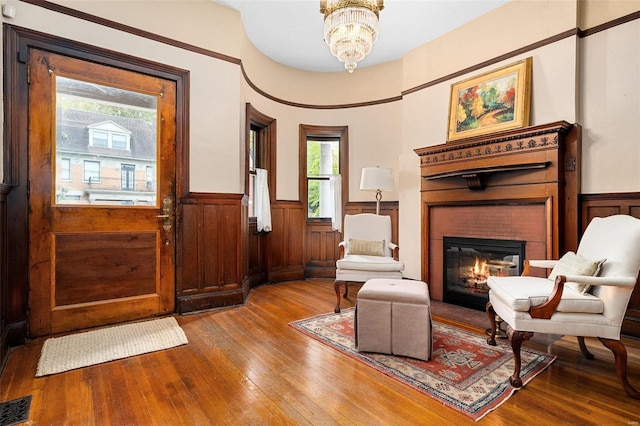 sitting room with hardwood / wood-style flooring and a notable chandelier