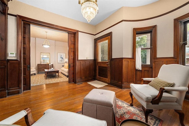 living area featuring a chandelier and light wood-type flooring