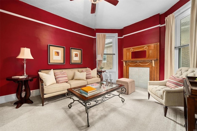 living room with carpet flooring, a wealth of natural light, and ceiling fan