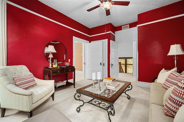 carpeted living room with ceiling fan