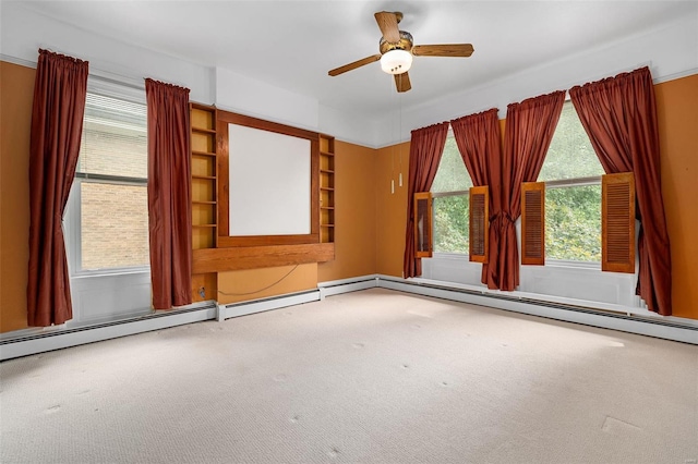 empty room featuring carpet flooring, ceiling fan, and baseboard heating