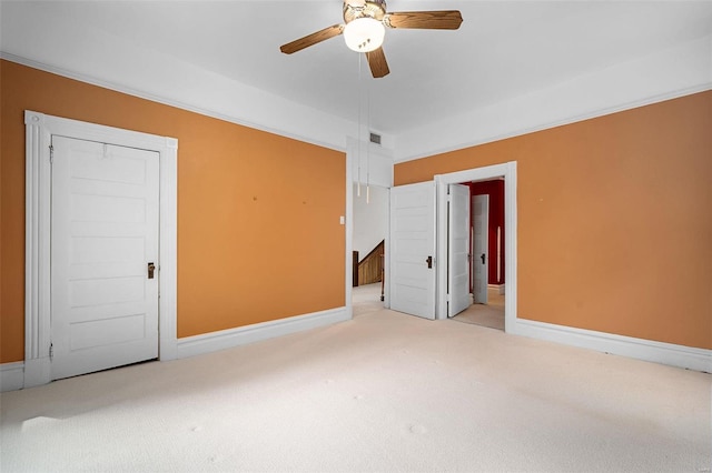 unfurnished bedroom featuring light carpet, a closet, and ceiling fan